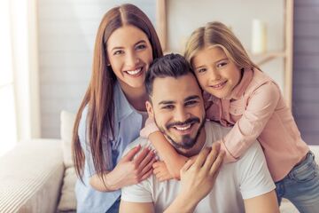 woman, man, child smiling with great teeth