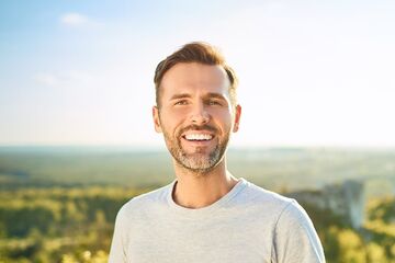 man smiling showing teeth