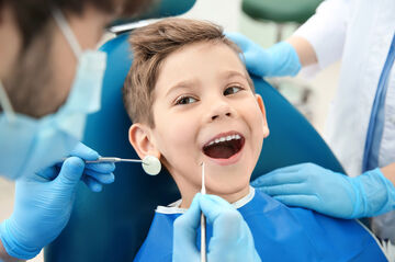 boy in dentist chair receiving treatment