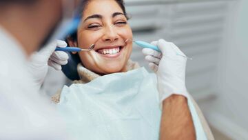 woman receiving dental treatment smiling
